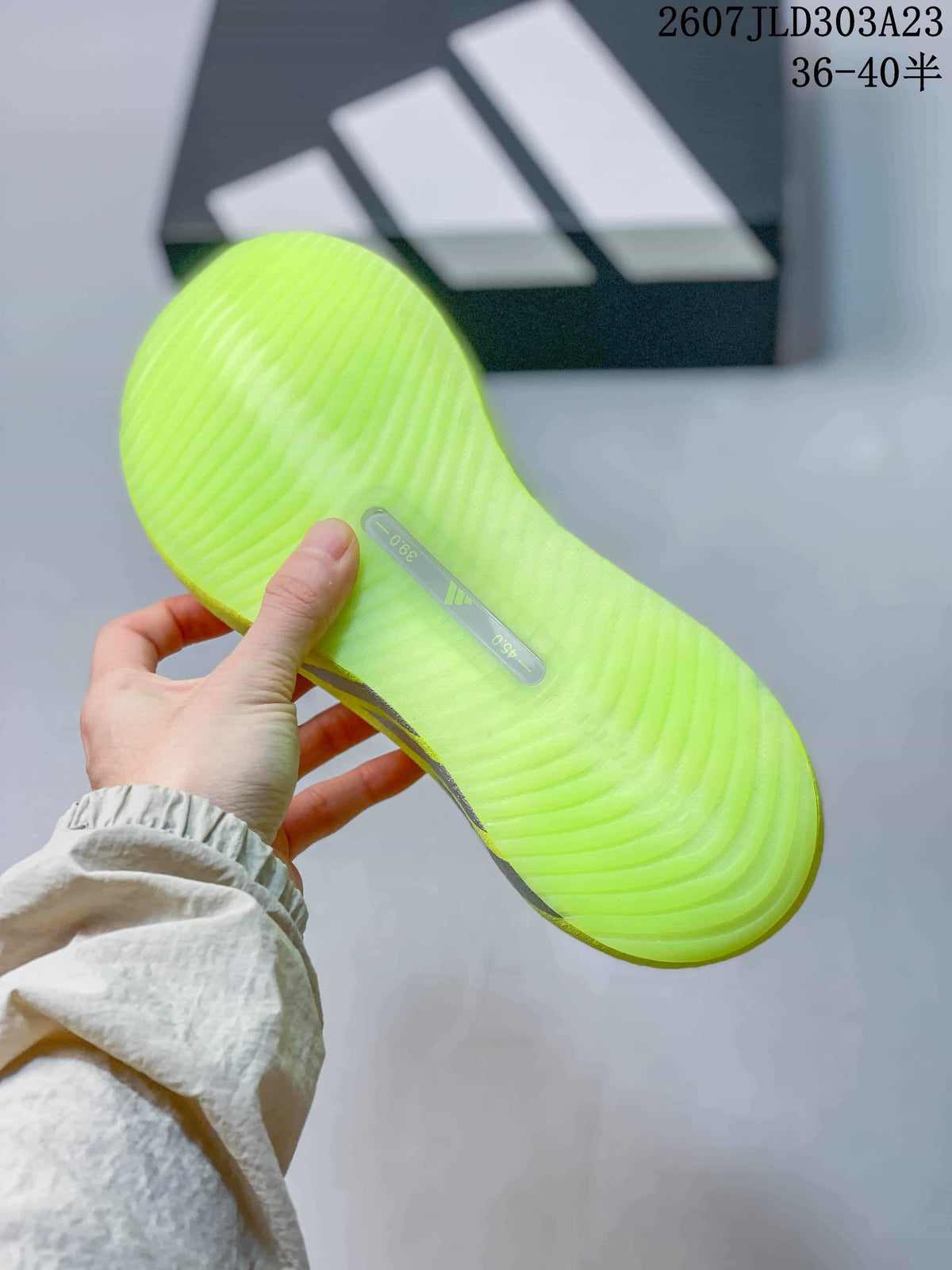Close view of the textured neon yellow-green outsole with a central insert.