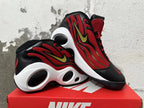 Pair of red, black, and white Nike Flight sneakers displayed at an angle