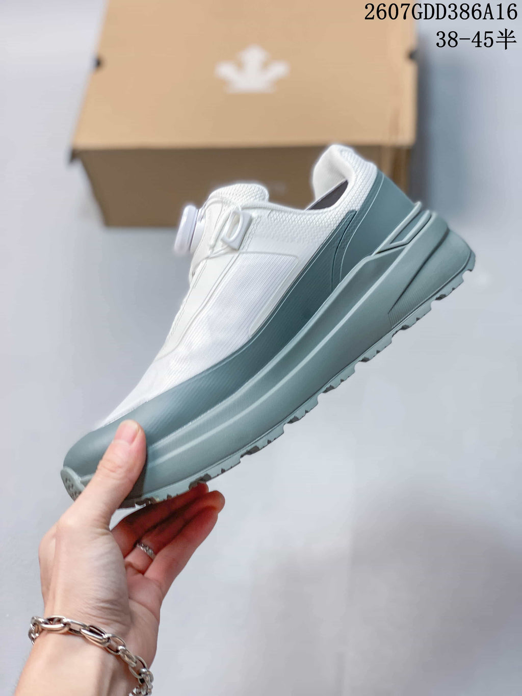 Side profile of the white and gray low-top sneaker showing its layered upper and thick midsole.