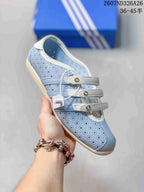 Side view of a light blue and white perforated adidas Anfu trainer with three front straps.