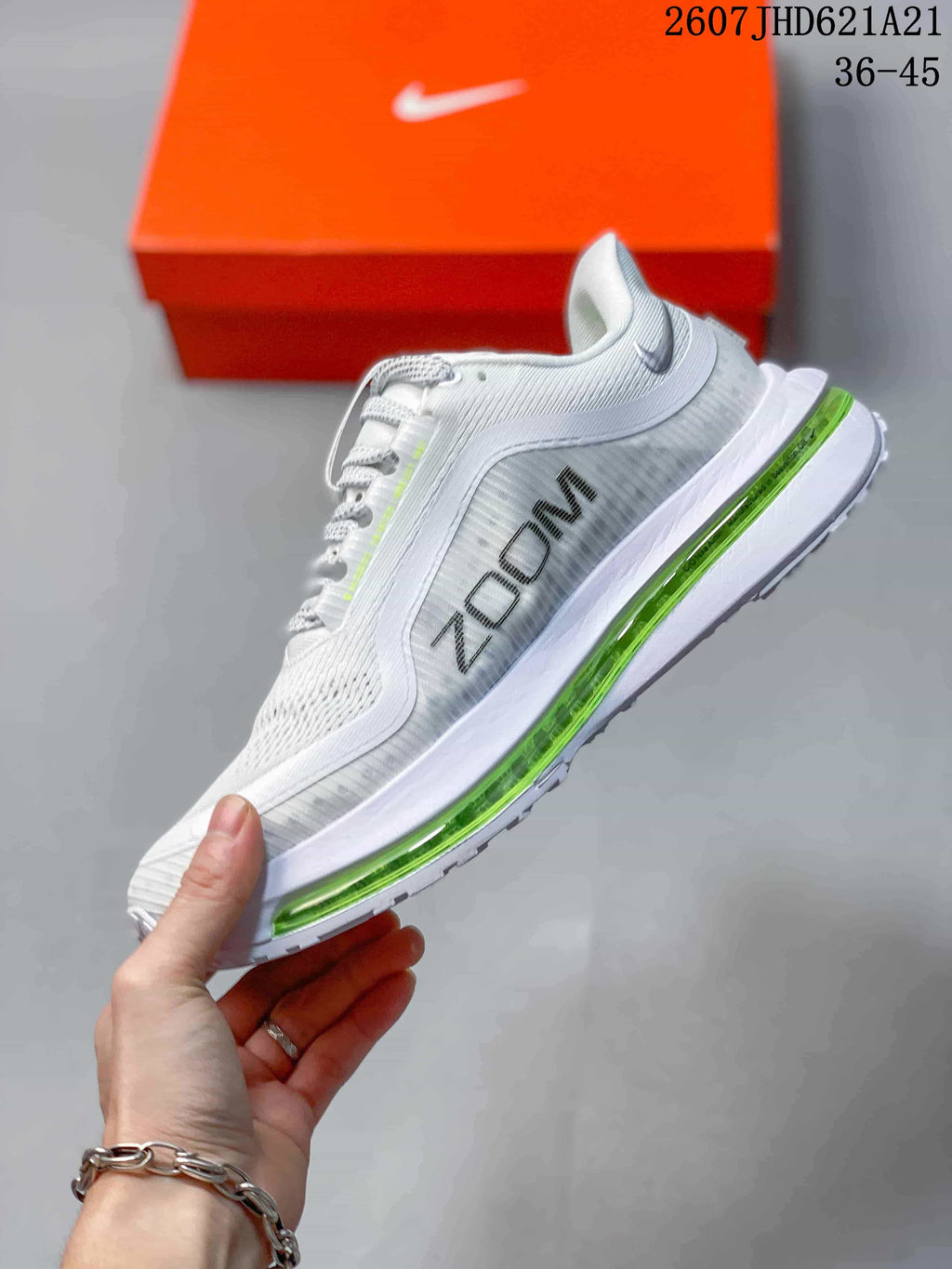 Side view showing the white mesh upper, blue Nike branding, and green cushioning unit.