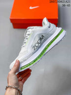Side view showing the white mesh upper, blue Nike branding, and green cushioning unit.