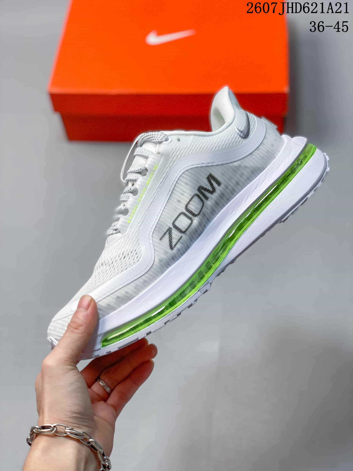 Side view showing the white mesh upper, blue Nike branding, and green cushioning unit.