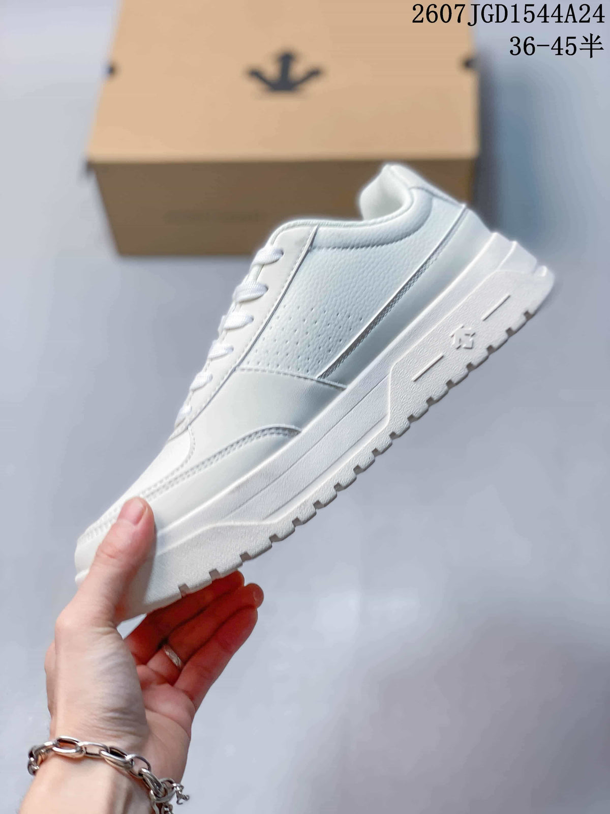 Side view of the white low-top sneaker showing the perforated panel, layered upper and textured sole.