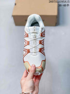 Top view showing the white upper, bronze overlays and cord-style lacing system.