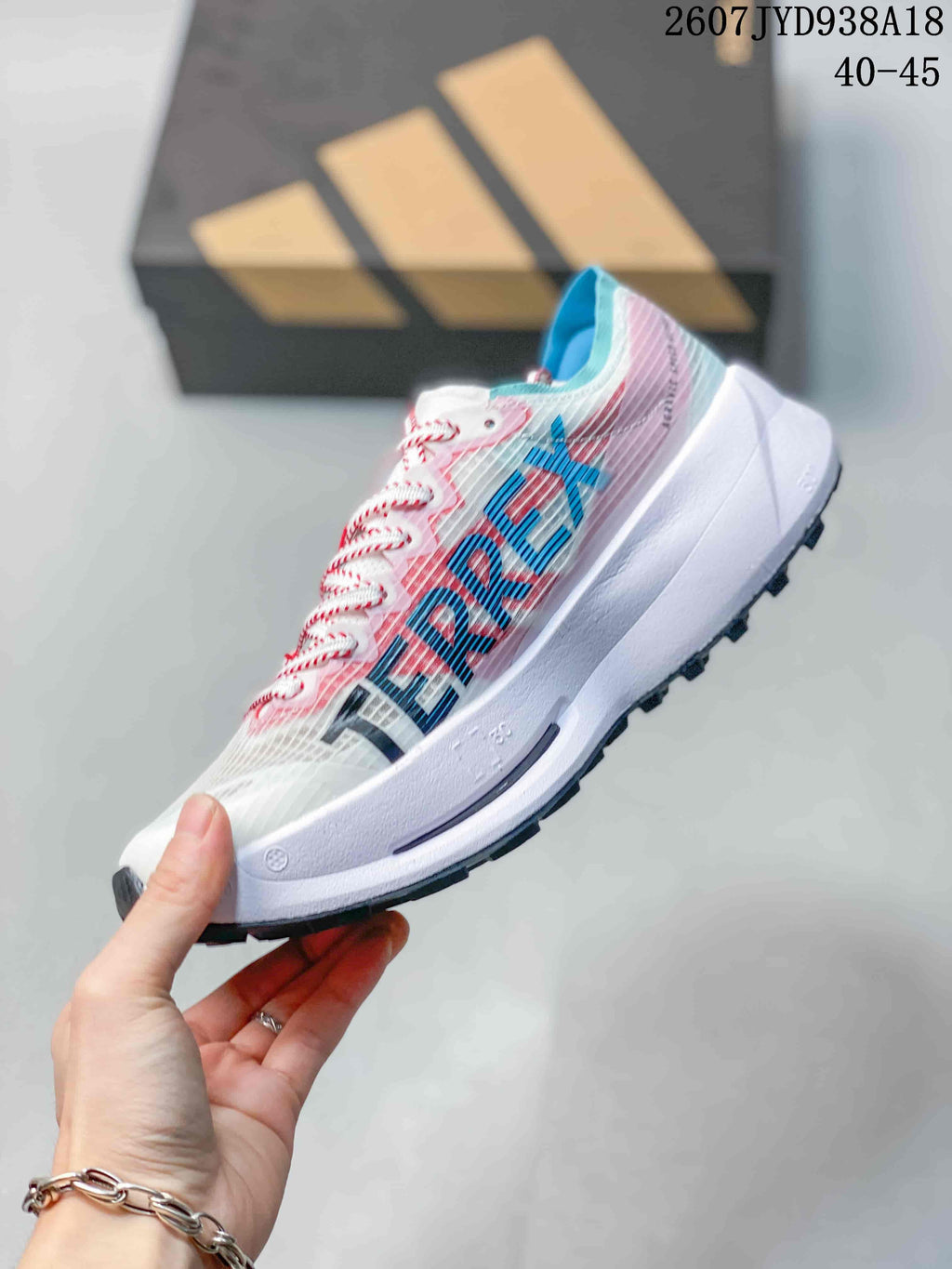 Side view of the running shoe showing large blue and black branding details, pink upper accents, and a white midsole; size range text 40–45 is visible.