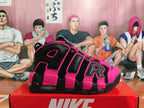 Side view showing oversized AIR lettering on black and bright pink Nike sneakers