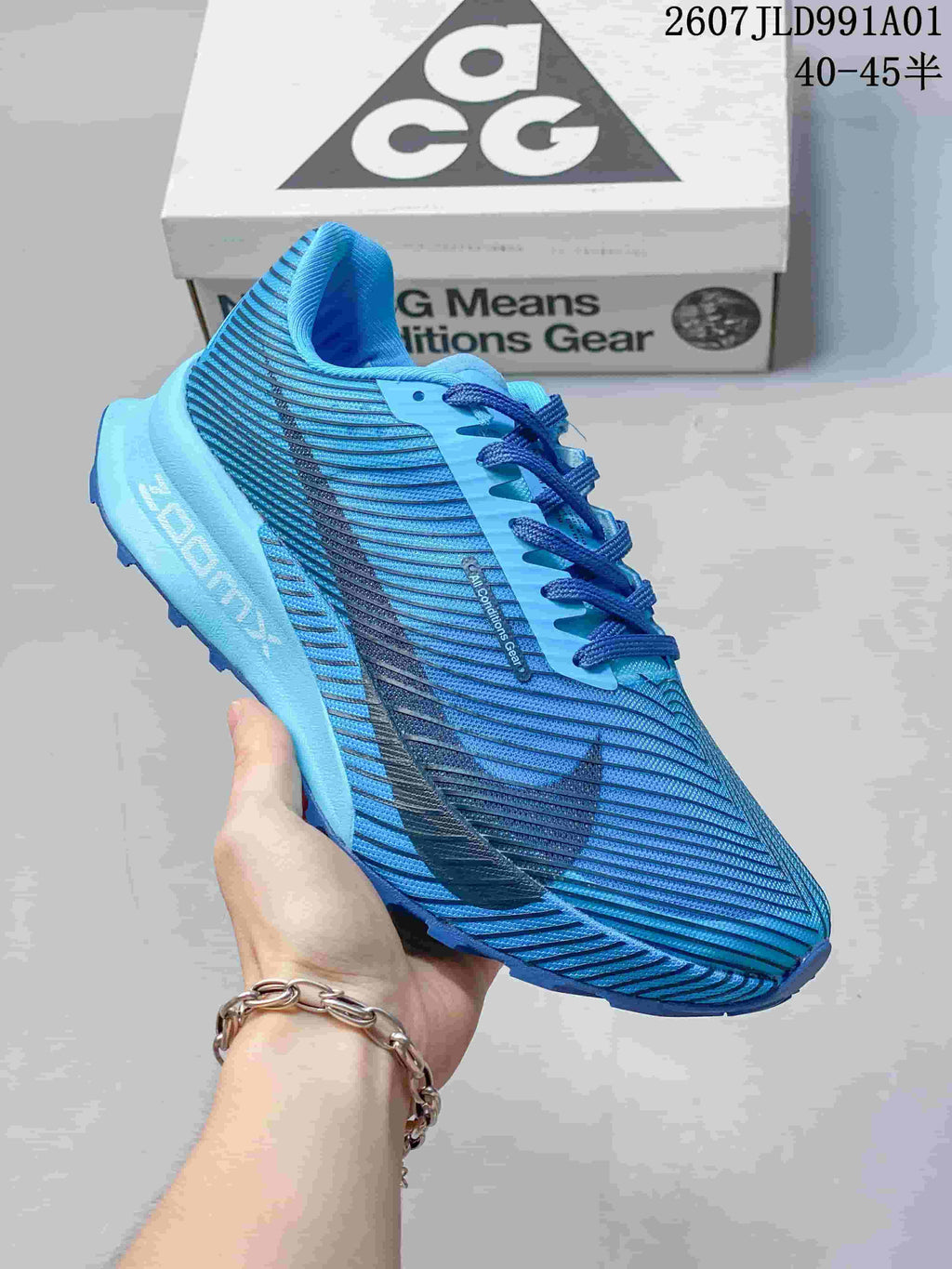Side view of a blue Nike ACG trail shoe with a lugged outsole