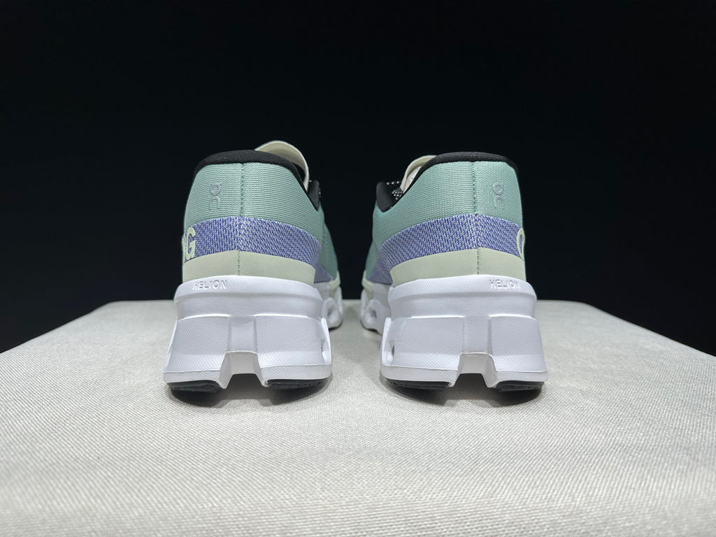 Rear view of the pair showing purple heel bands and sculpted white soles.