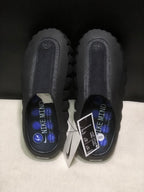 Top-down view showing the textured footbed, Nike Mind branding, tags, and size label.