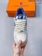 Front view showing the perforated toe, white laces, and blue tongue detail