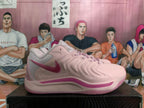 Side view of a pink Nike basketball shoe with a darker pink Swoosh and midsole detail.
