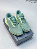 Pair of green and lime Nike ACG Ultrafly Trail sneakers displayed on a shoe box.