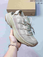 Angled close-up of the beige Terrex shoe with mesh panels and thick sole
