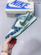 Side profile showing the white base, green Swoosh detail, blue patterned overlays and stitched construction.