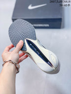 Close-up of the shoe outsole showing a dark patterned tread and visible Flyplate branding.