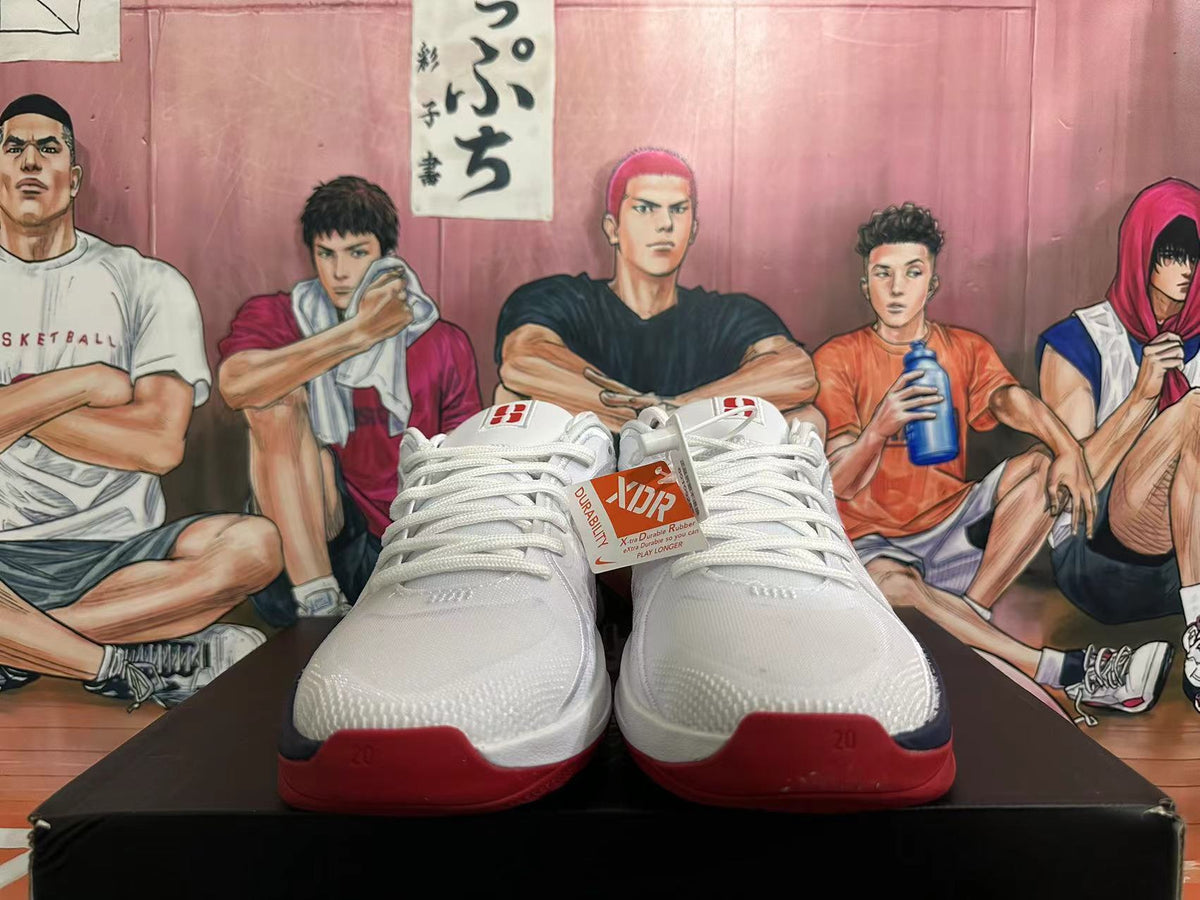 Front view of the white basketball shoes with lace-up closure and red outsole details.
