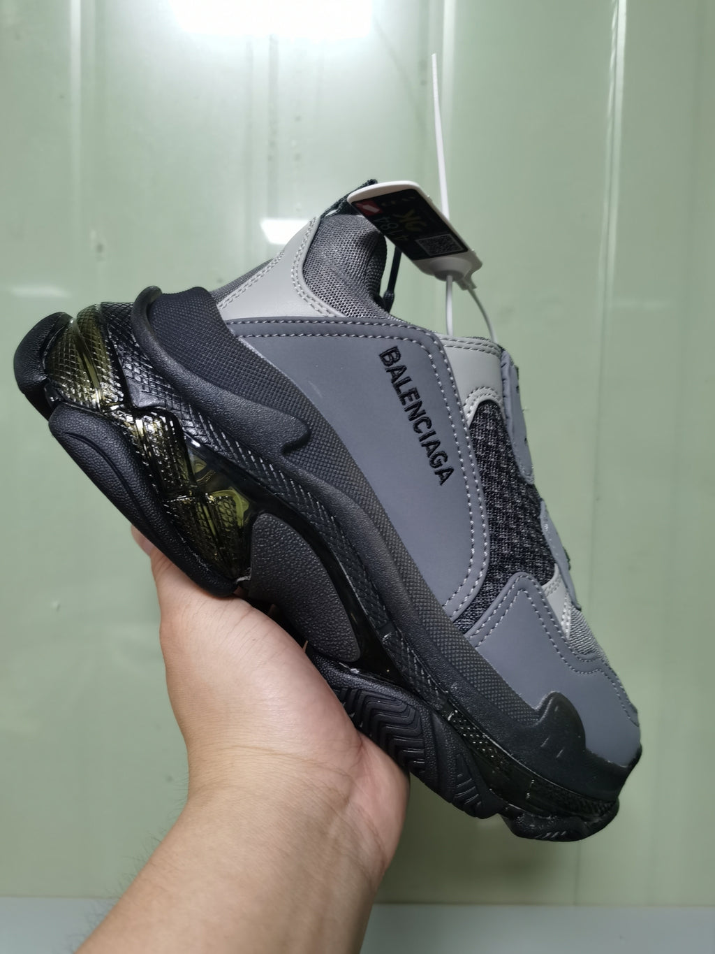 Angled view of the Balenciaga Triple S sneaker showing the layered upper, side branding, and chunky sole.