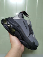 Angled view of the Balenciaga Triple S sneaker showing the layered upper, side branding, and chunky sole.