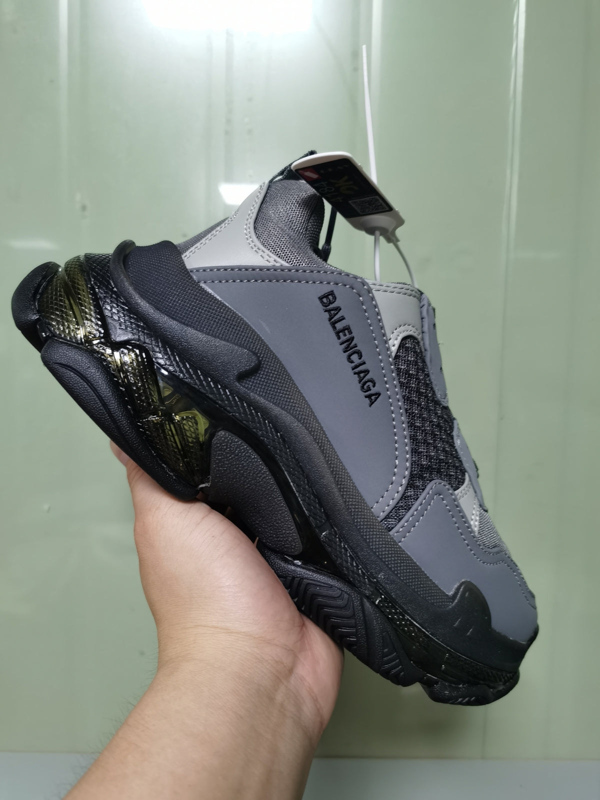 Angled view of the Balenciaga Triple S sneaker showing the layered upper, side branding, and chunky sole.