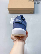 Rear view of a blue Terrex sneaker with a heel pull tab and light-colored sole.