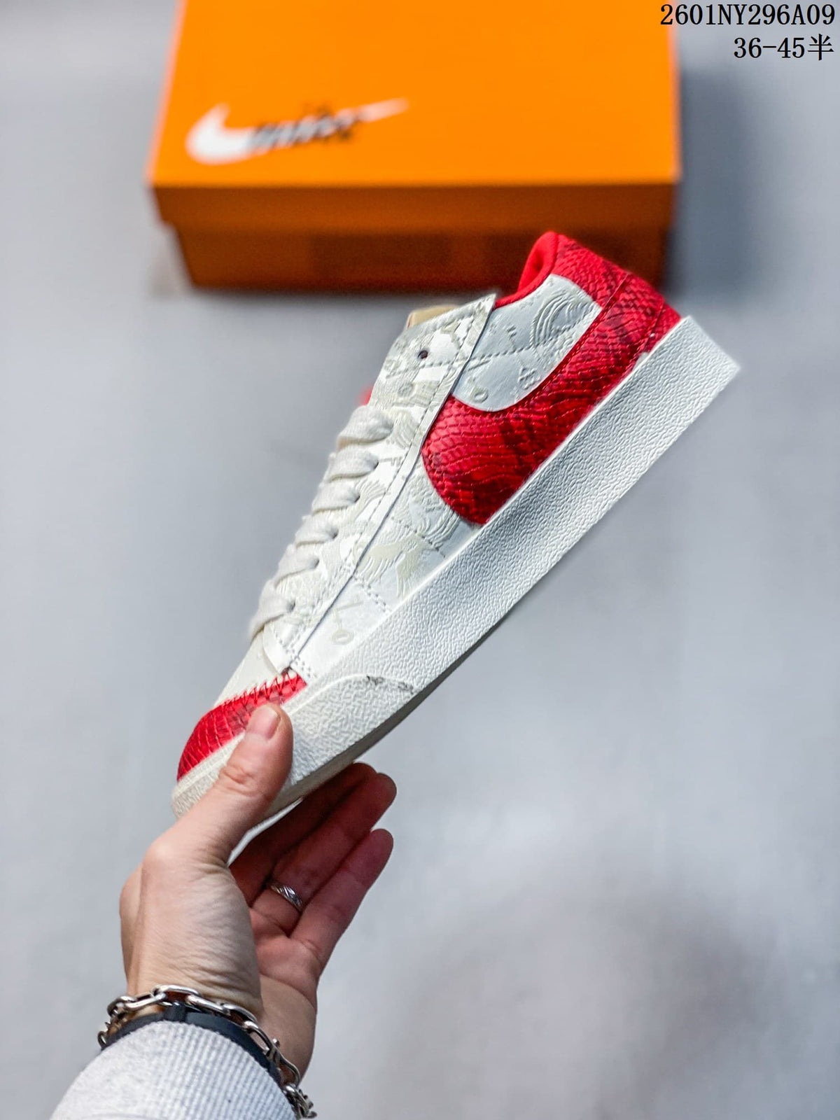 Side view showing the oversized red Swoosh, white upper, and textured panel details.