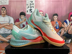 Pair of mint, cream, and coral low-top basketball shoes displayed at an angle.