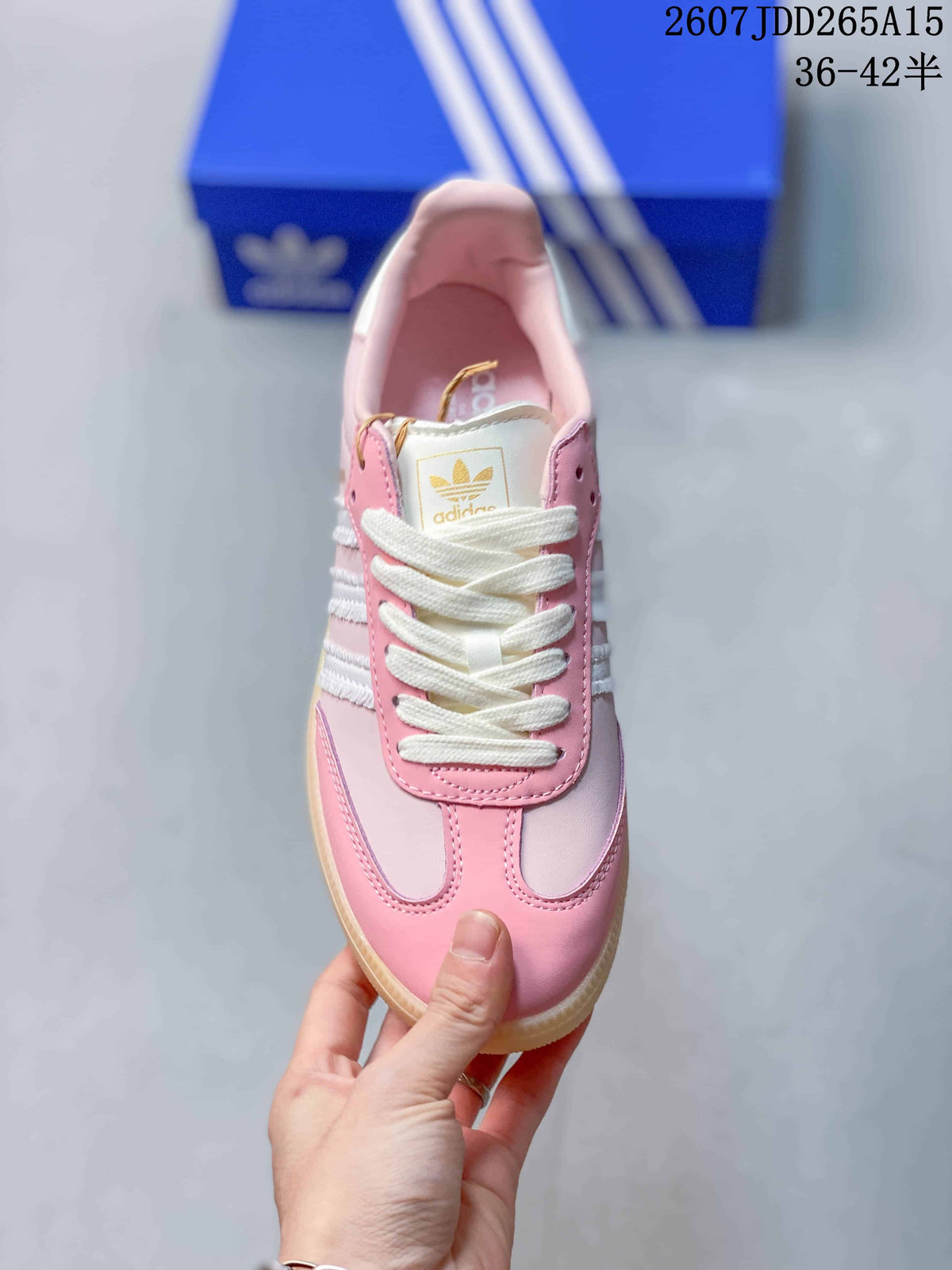 Top view of the pink sneaker showing white laces, layered toe detailing, and the adidas trefoil tongue label.