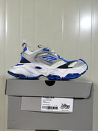 White, grey, and blue Skechers sneaker displayed on its shoebox, with the box label visible.