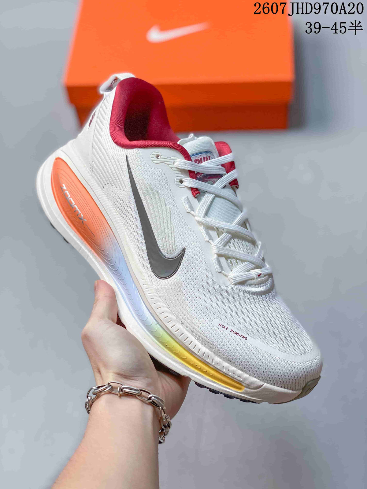 White Nike Structure Plus running sneaker with a dark Swoosh, red collar detail, and multicolor midsole accents.