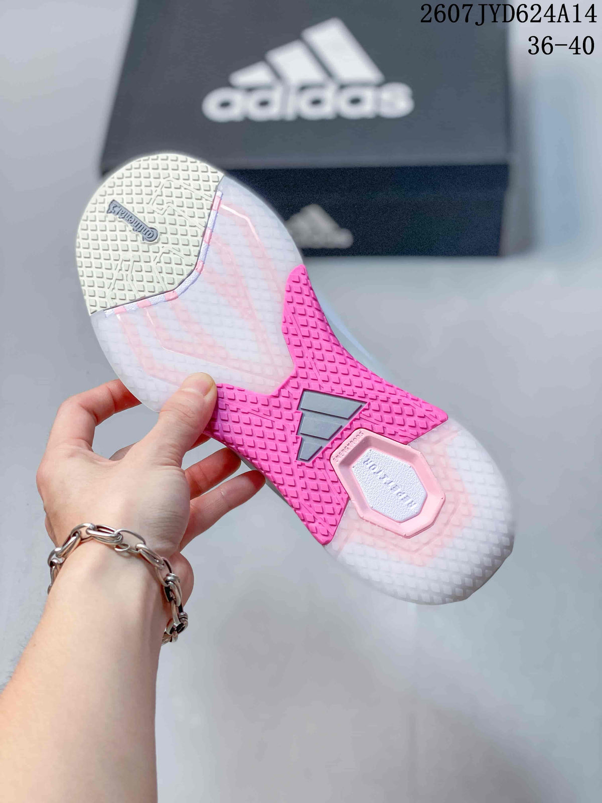 Underside view showing the textured outsole with bright pink traction sections and adidas branding.