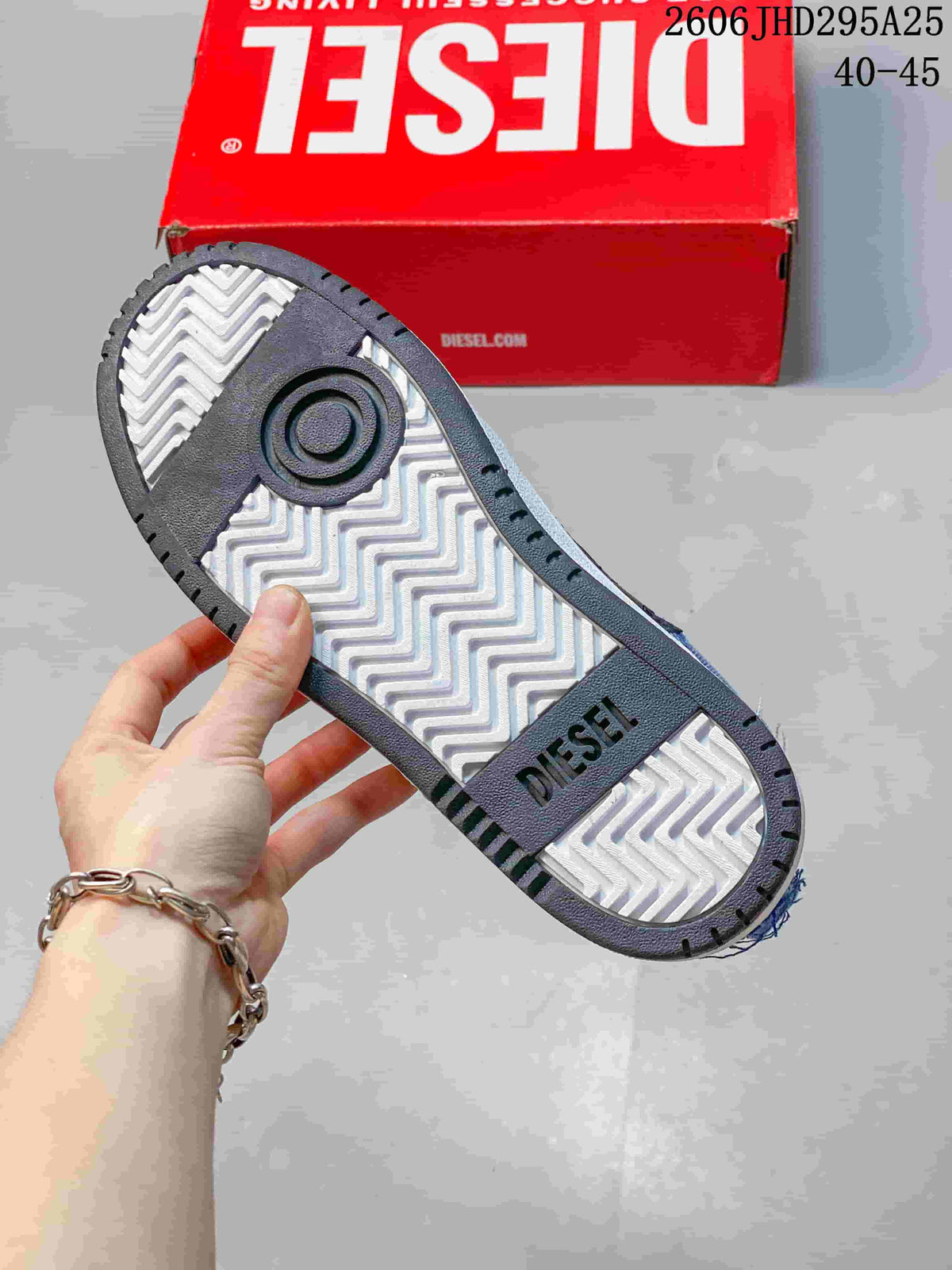 Underside of a sneaker showing a patterned outsole and Diesel lettering.