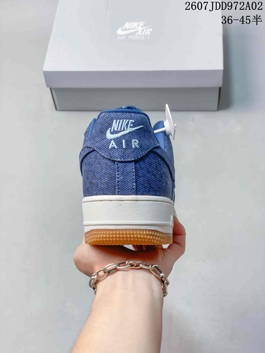 Rear view showing the blue heel and white midsole of the sneaker