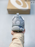 Rear view of the gray sneaker showing the GEL logo, padded collar, and layered heel construction.