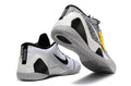White and black Kobe 9 Low basketball shoes shown from the heel and outsole.