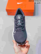 Top view showing the lace-up construction, dark gray upper, and white side logo.