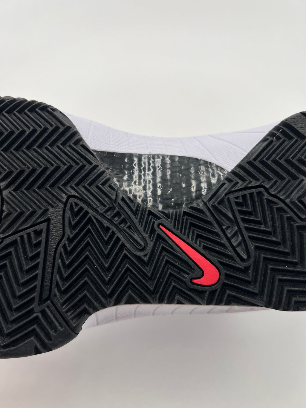 Close-up of the black outsole tread and red Swoosh detail