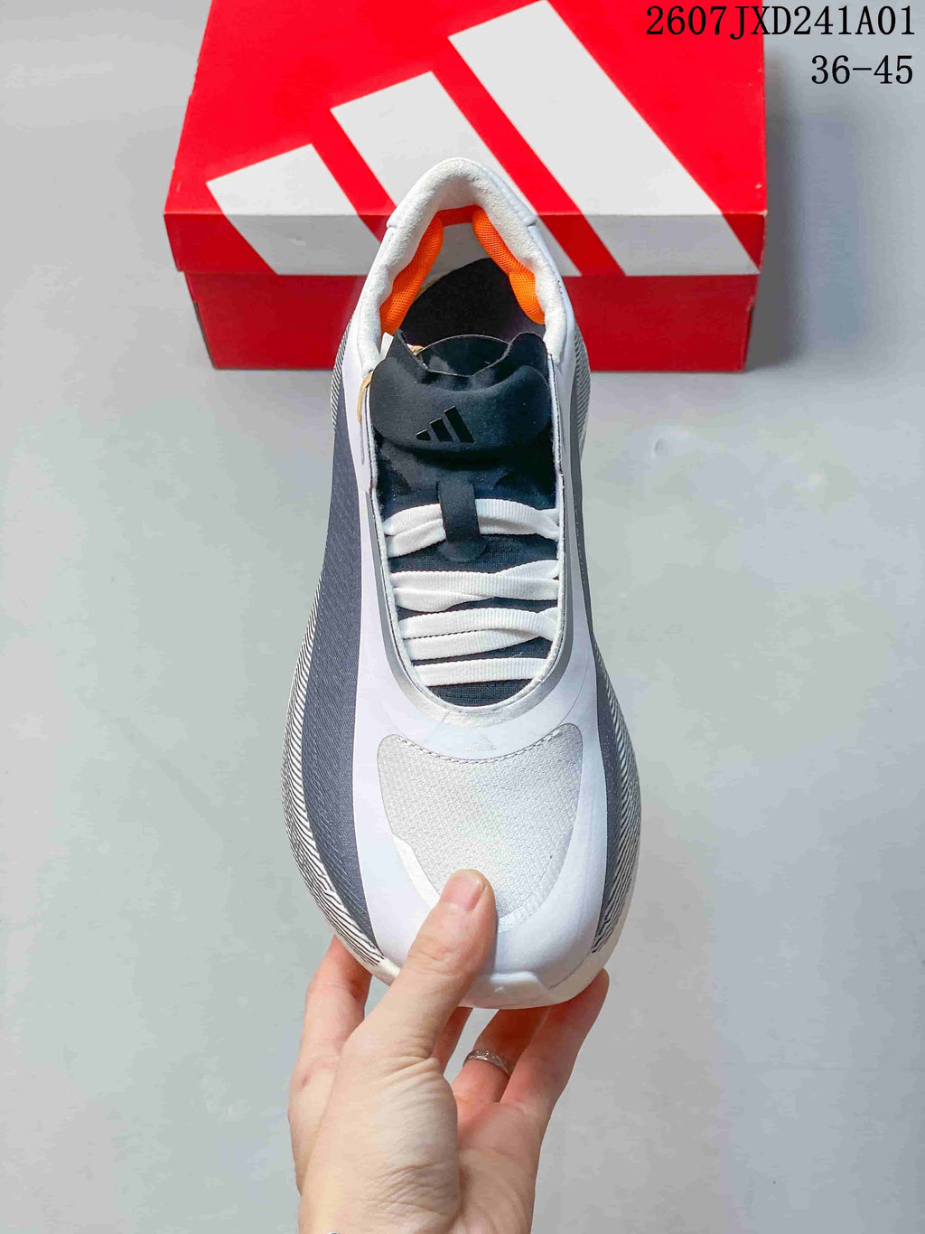 Top view showing the laces, dark tongue, and orange lining
