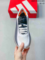 Top view showing the laces, dark tongue, and orange lining