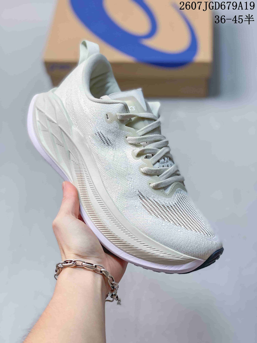 Angled side view of a white ASICS Superblast 2 running sneaker showing the textured upper, ASICS side branding, layered midsole, and dark outsole tip.