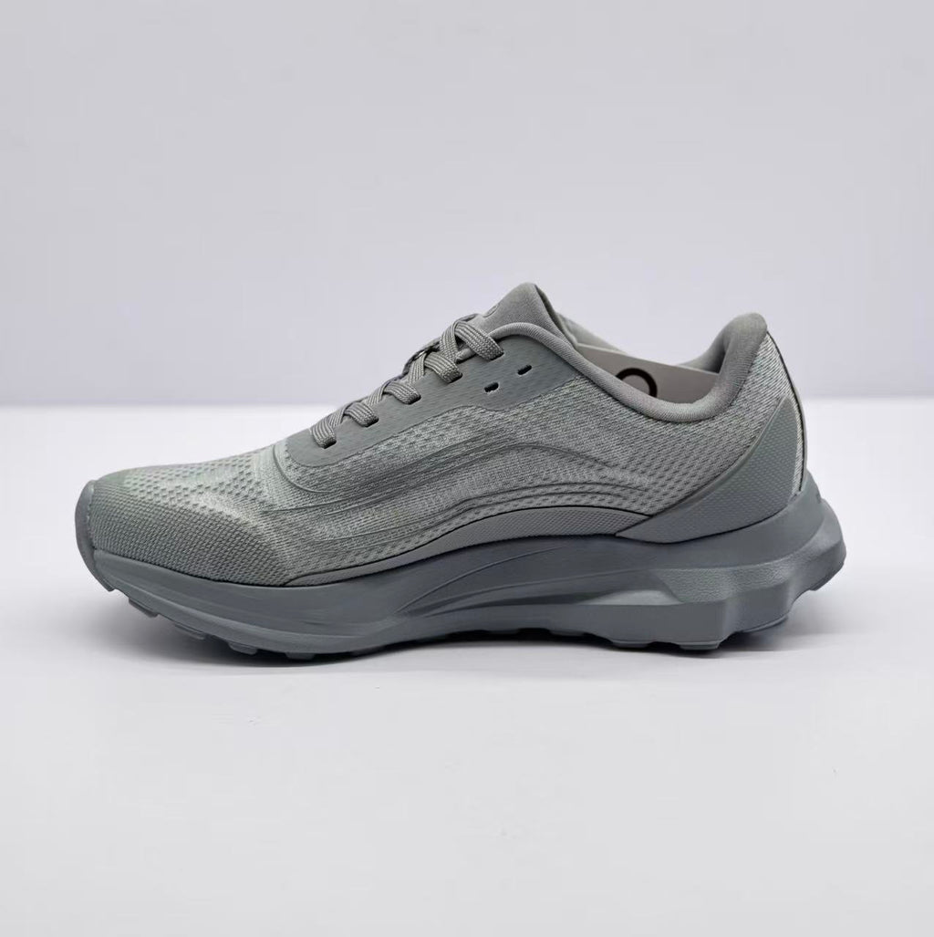 Opposite side view of the gray Alo Runner sneaker showing the textured upper and raised heel structure.