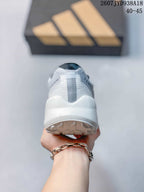 Rear view of the white running shoe showing the heel counter, vertical heel detail, and outsole tread.