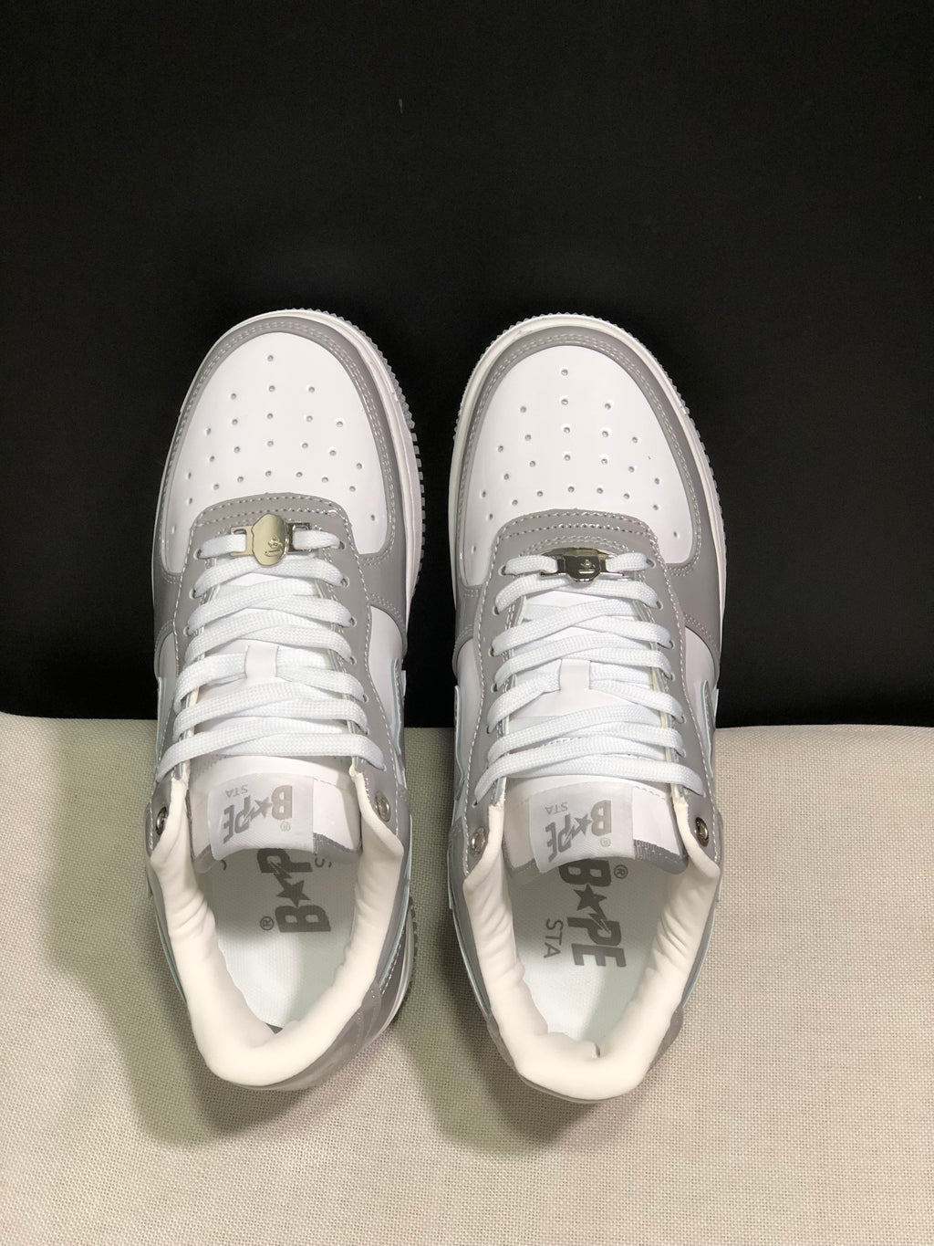 Top view showing white laces, perforated toe boxes, grey overlays and BAPE Sta insoles.