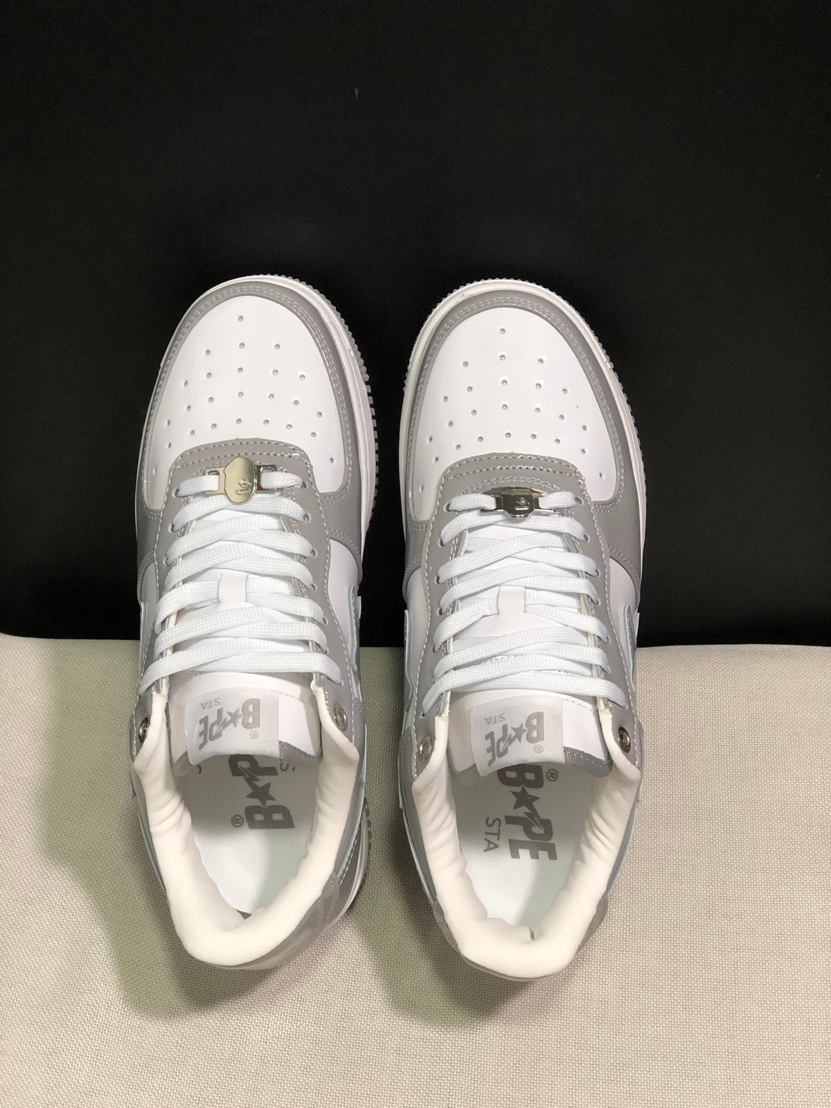 Top view showing white laces, perforated toe boxes, grey overlays and BAPE Sta insoles.