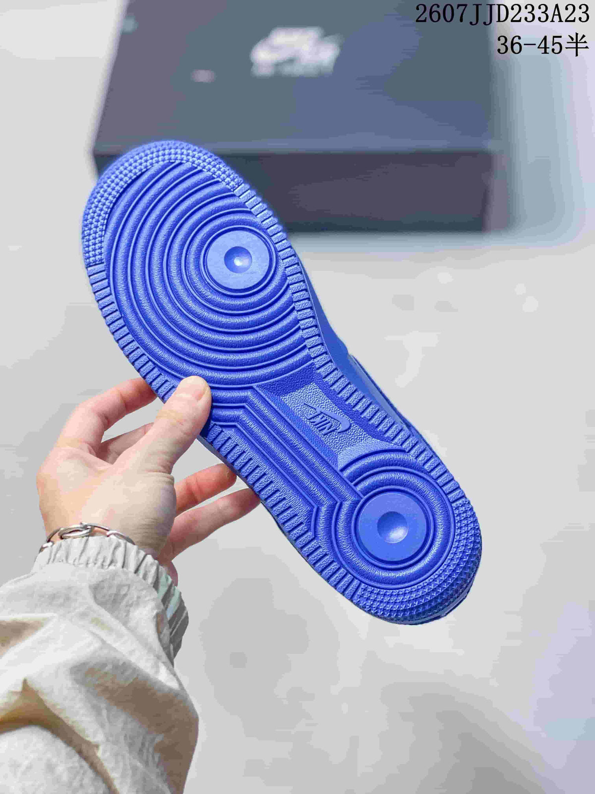 Blue rubber outsole of the sneaker showing circular and linear traction patterns.