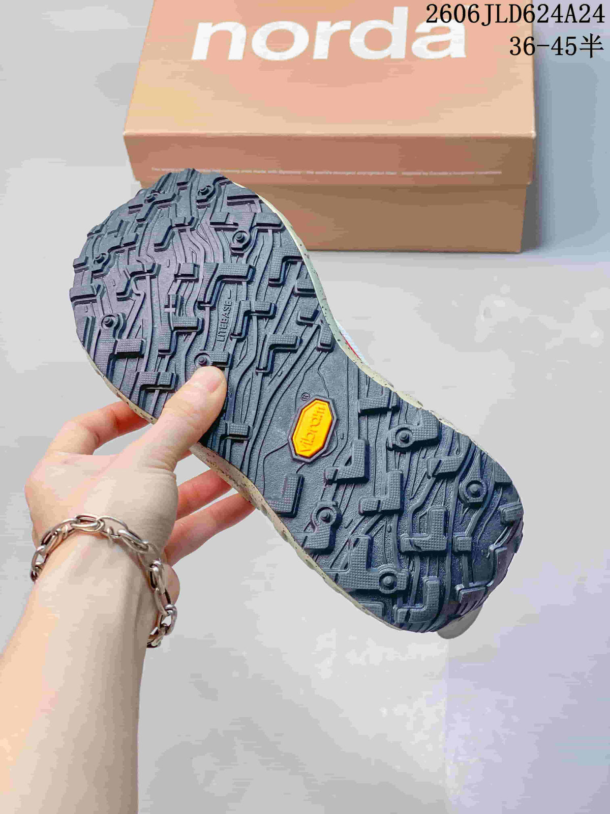 Close-up of the dark patterned outsole with a yellow Vibram badge.