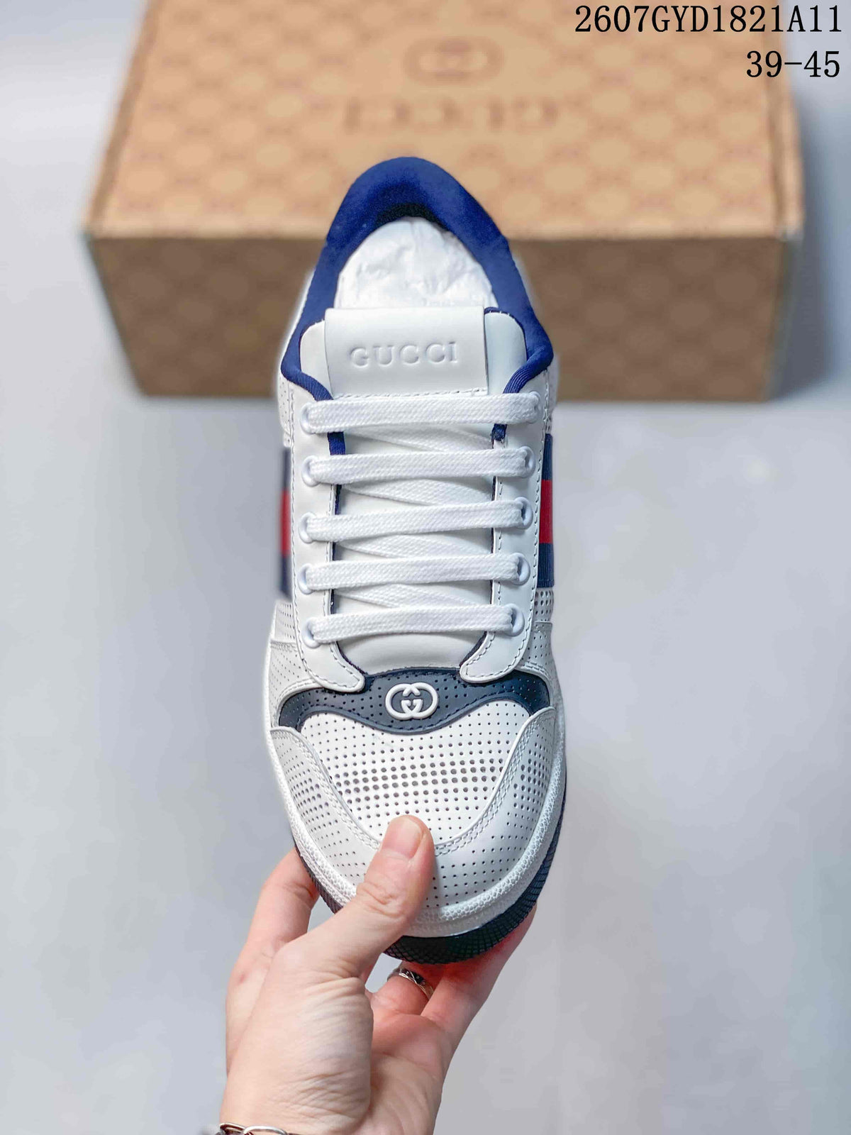 Top view showing the white laces, perforated toe box, navy trim, and Gucci branding on the tongue.