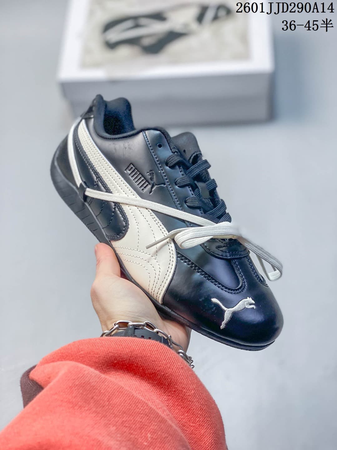 Side view of a navy PUMA Speedcat TTF sneaker with a white side stripe and crossing decorative laces.