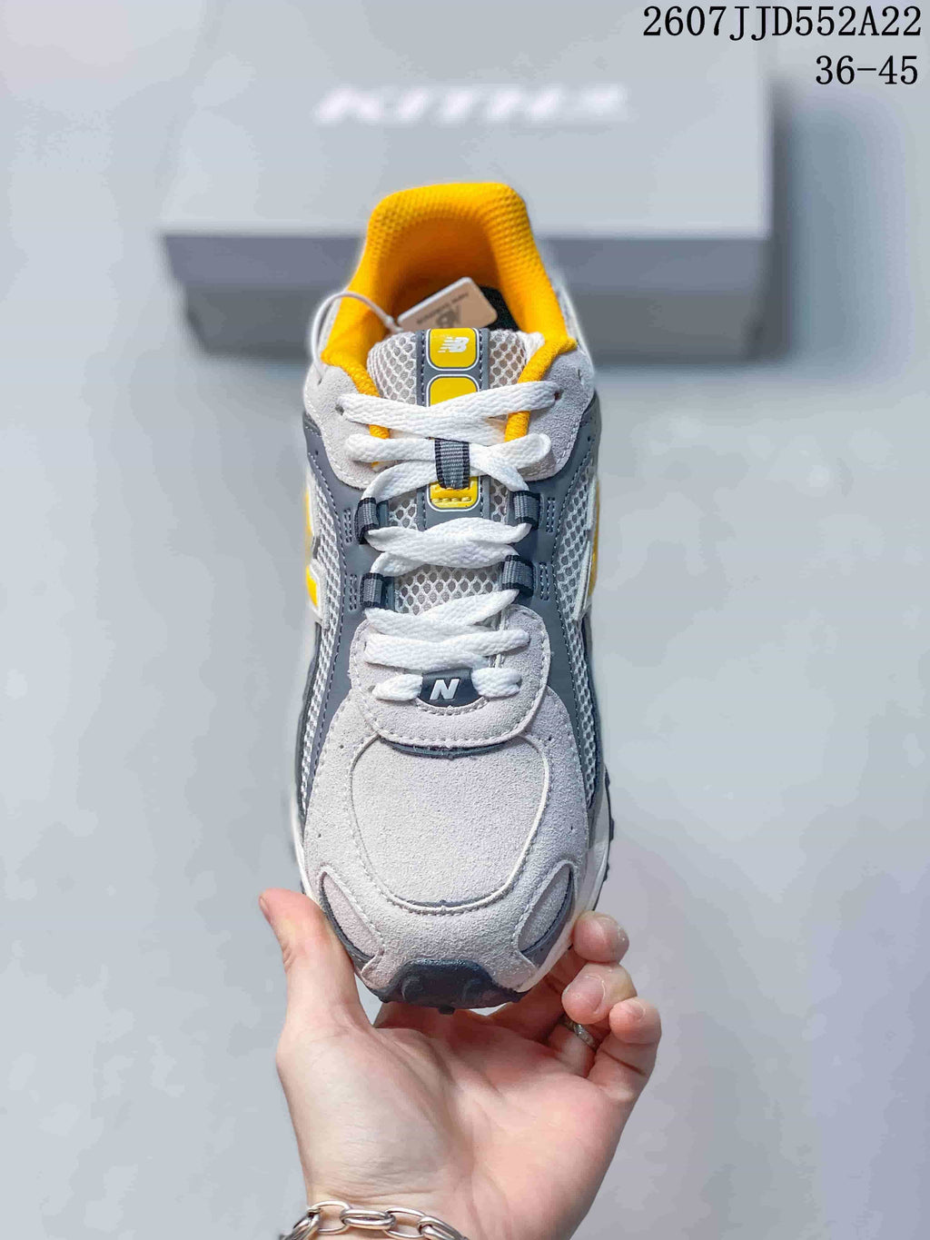 Top view showing the white laces, mesh tongue, grey toe area, and yellow lining.