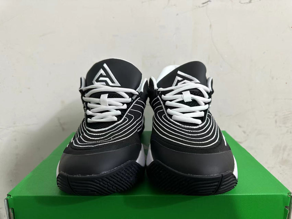 Front view showing white laces and curved white detailing on black Nike sneakers